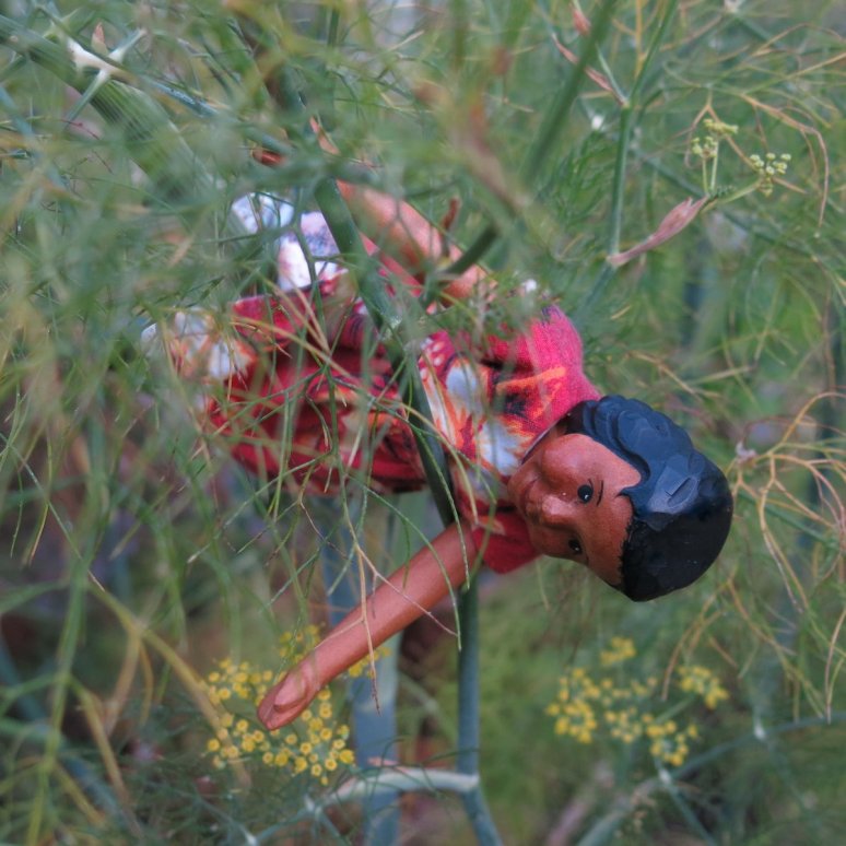 dangling precariously